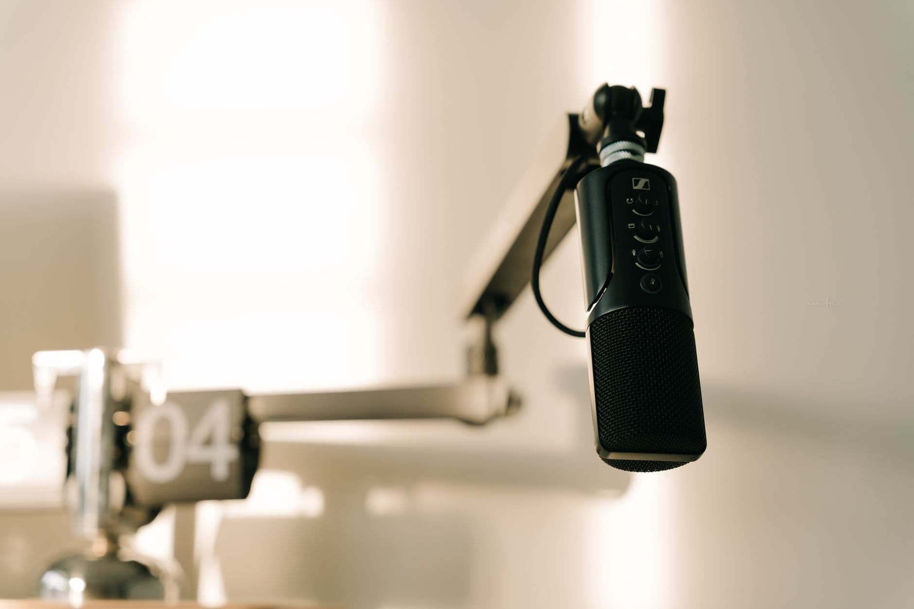 Close-up of a professional microphone on a boom arm, ideal for faceless YouTube creator audio setup.