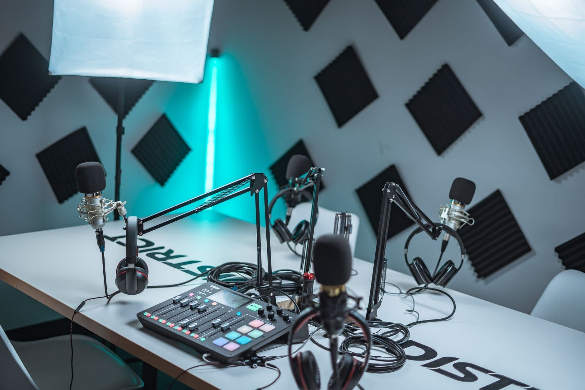 Faceless YouTube creator's podcast setup with multiple microphones and headphones.