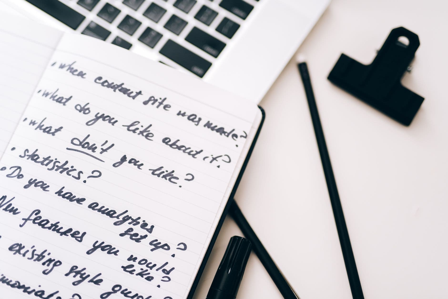 Faceless YouTube creator's handwritten notes on a notebook for content research and planning.