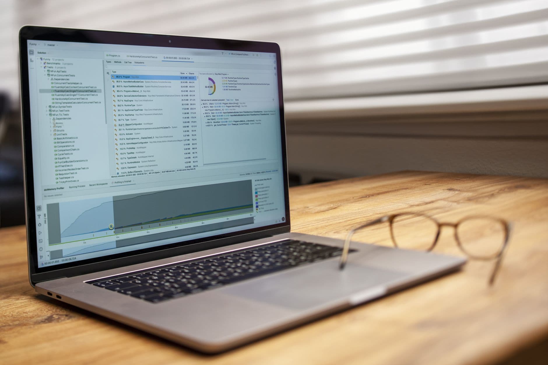 Faceless YouTube creator's laptop displaying code and analytics for workflow optimization.