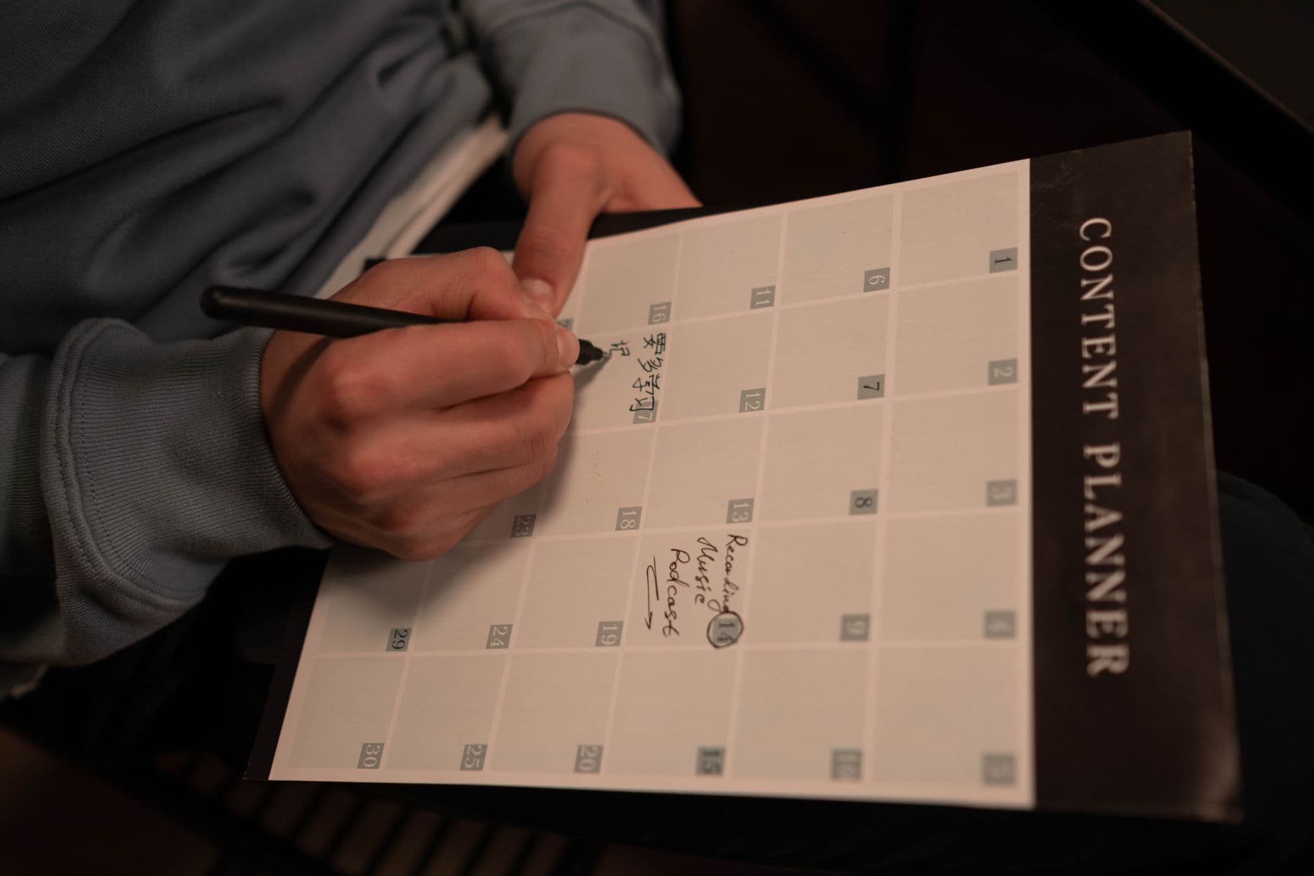 Faceless YouTube creator's content planner with notes for scripting and podcasting.