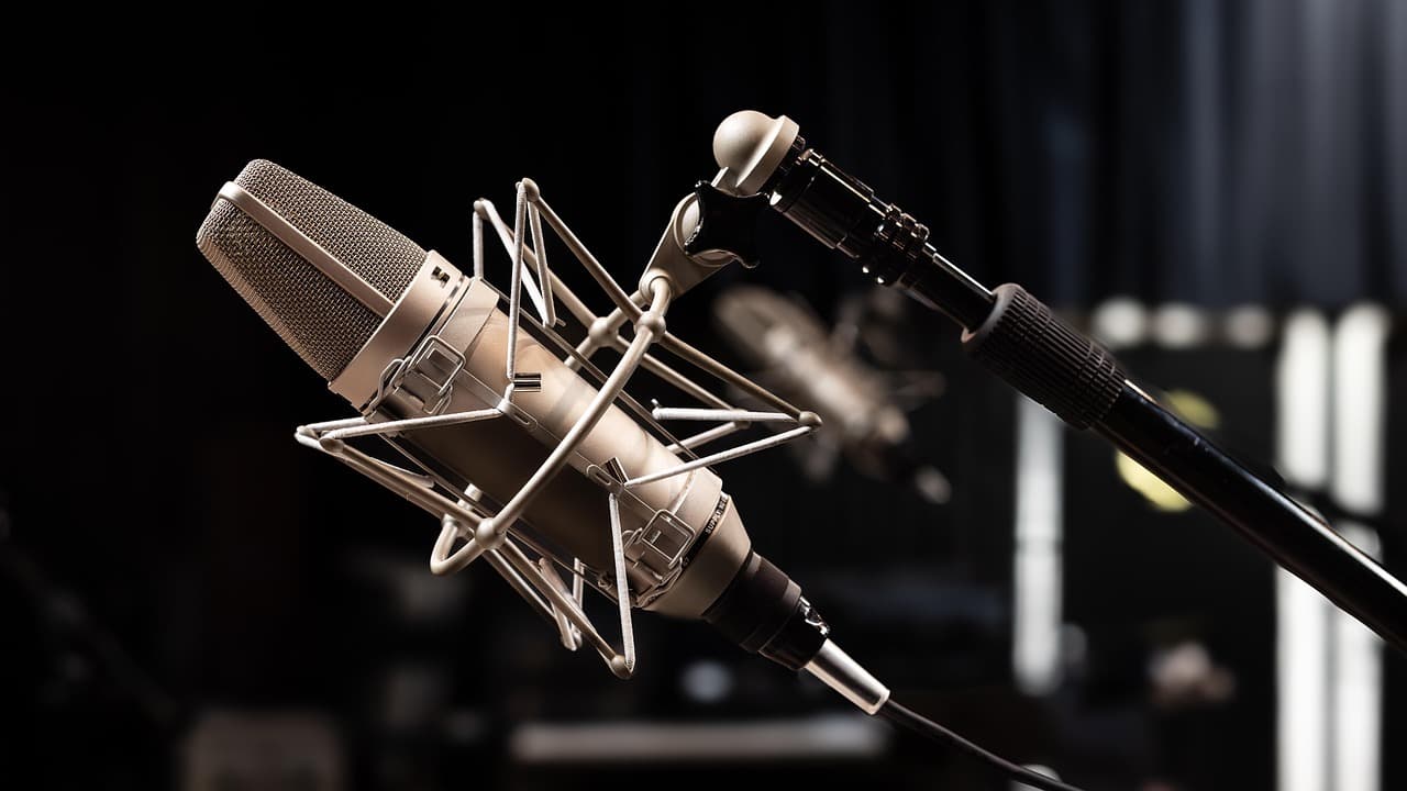 Close-up of a professional condenser microphone on a shock mount, ideal for faceless YouTube creator audio setup.