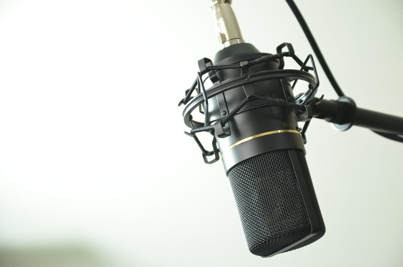 Close-up of a professional microphone on a stand, ideal for faceless YouTube creator audio setup.