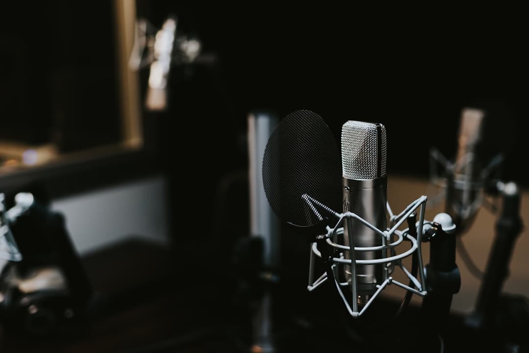 Faceless YouTube creator's studio setup with multiple microphones and headphones.