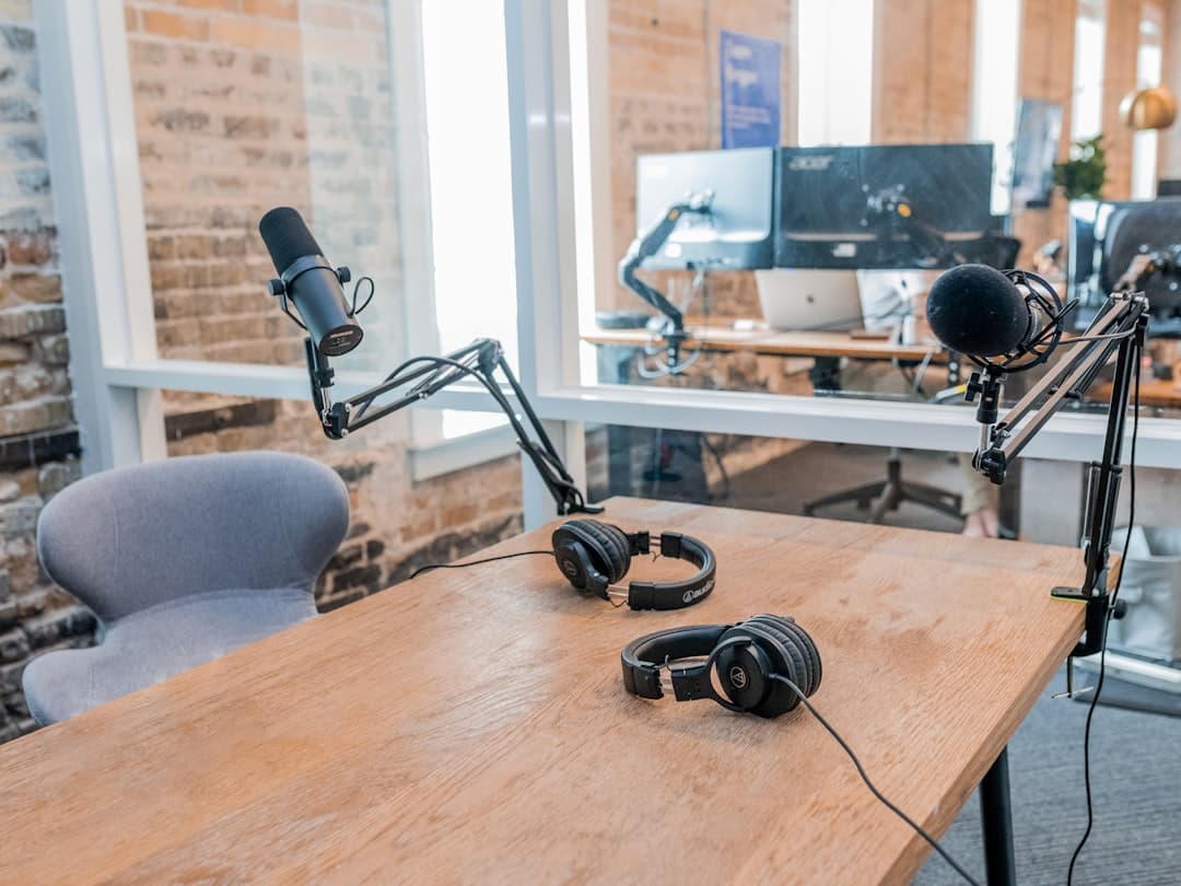 Podcast studio setup with microphones and headphones on a wooden table, ready for faceless YouTube content creation.