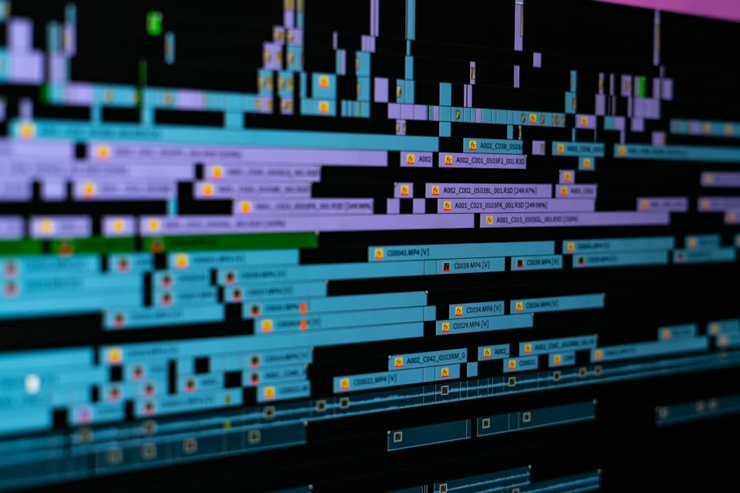 Close-up of a video editing timeline on a computer monitor, showing audio waveforms and video clips for content creation.