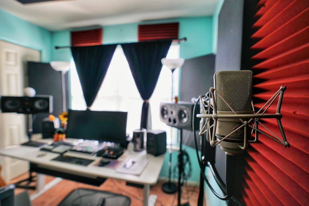 Faceless YouTube creator's studio setup with microphone and computer for video production.