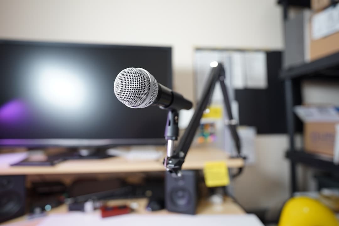 Faceless YouTube creator's microphone and monitor setup for workflow optimization.