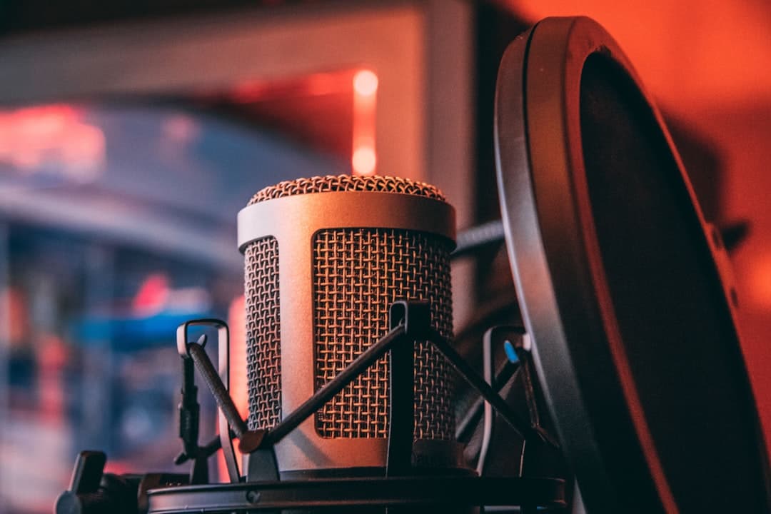 Close-up of a podcast microphone with a pop filter, suggesting a faceless YouTube creator's audio setup.