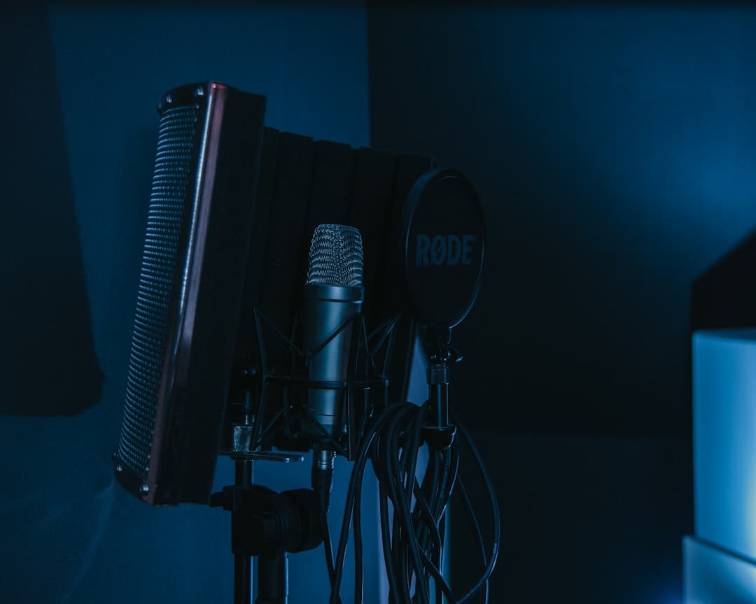 Microphone setup with pop filter and sound dampening for faceless YouTube audio recording.