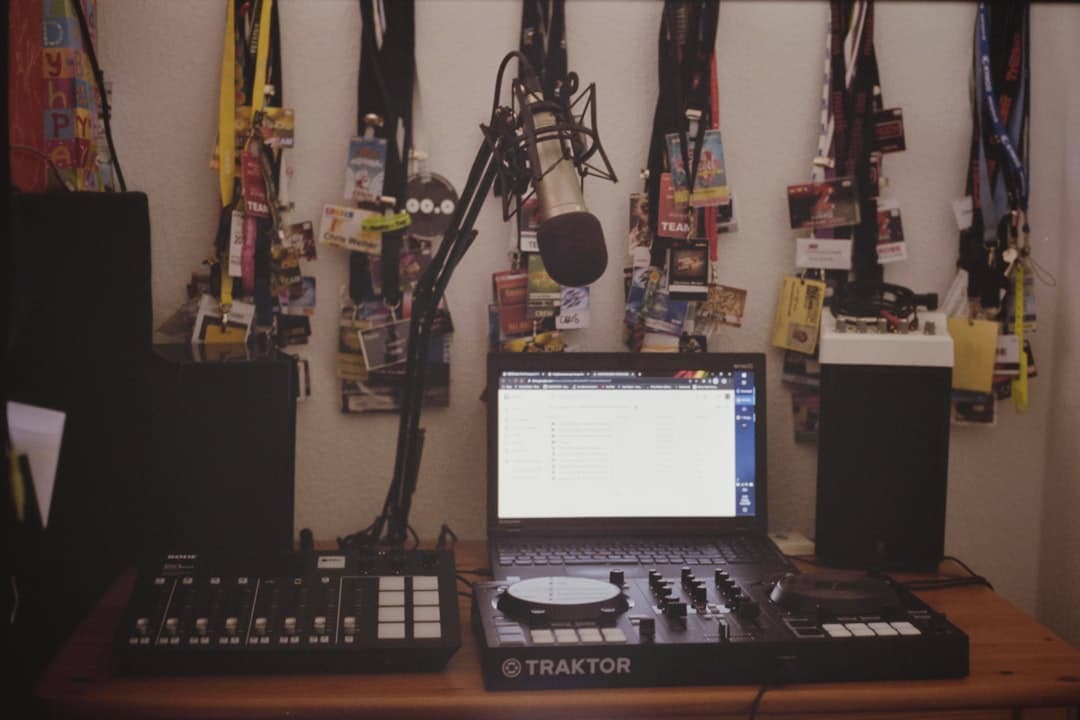 Faceless YouTube creator's audio setup with laptop, mixer, and microphone.
