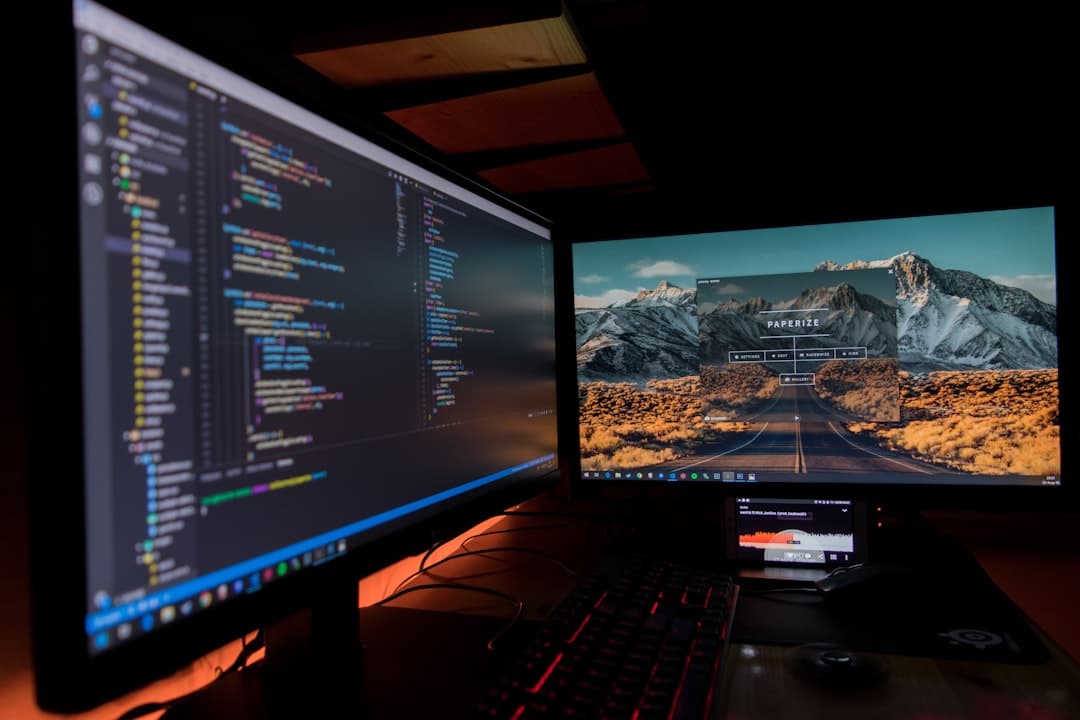 Dual monitors displaying code and a scenic desktop for faceless YouTube content creation.
