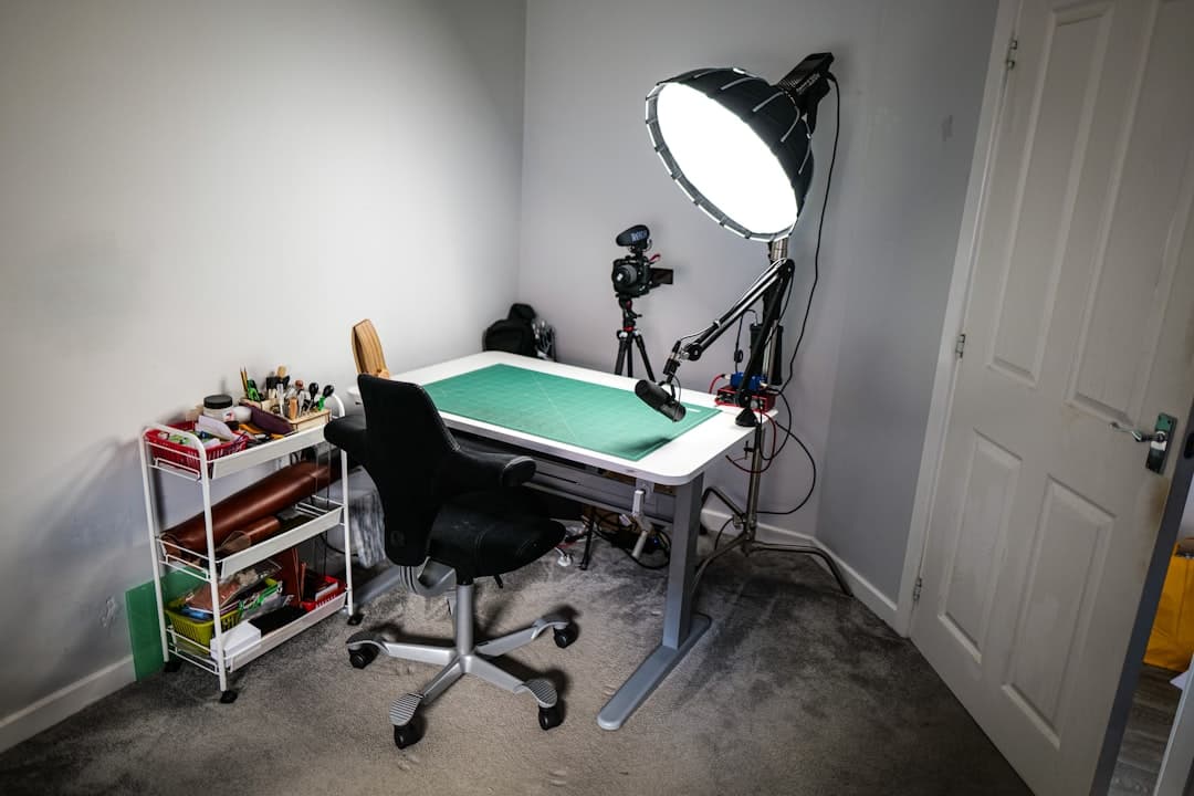 Faceless YouTube creator's home studio setup with desk, camera, and lighting for content creation.