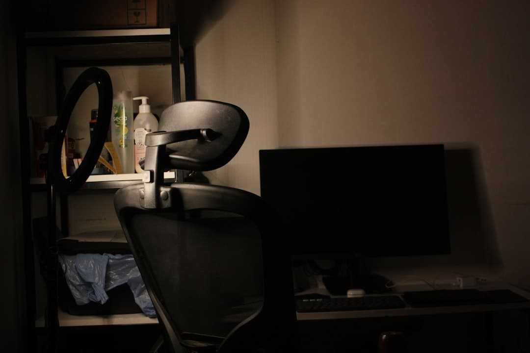 Empty creator workspace with a ring light, monitor, and chair, ready for faceless YouTube content creation.