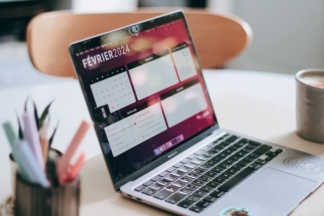 Laptop displaying a calendar for February 2024, part of a faceless YouTube creator's workspace.