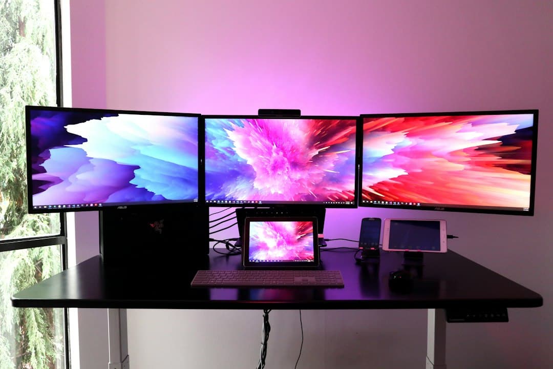 Faceless YouTube creator's multi-monitor setup for channel analytics and workflow management.