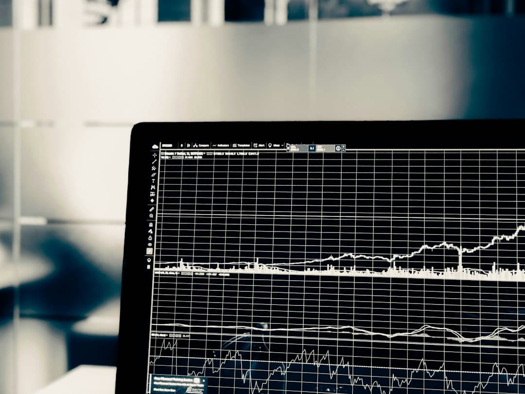 Computer monitor displaying financial analytics charts for workflow ROI analysis.
