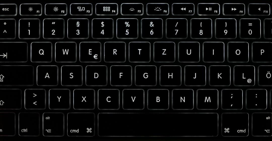 Close-up of a backlit keyboard, ideal for faceless YouTube creator workspace setup.